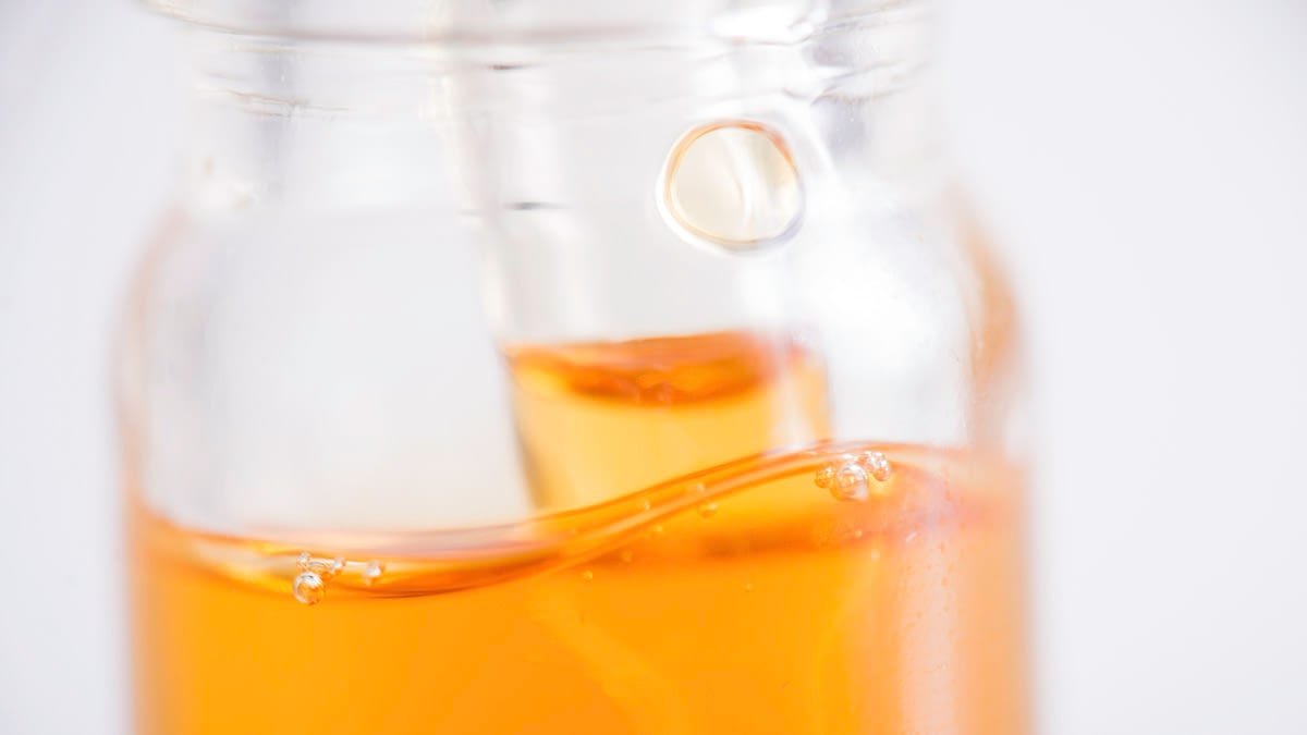 Macro detail of container with CBD oil inside a glass jar